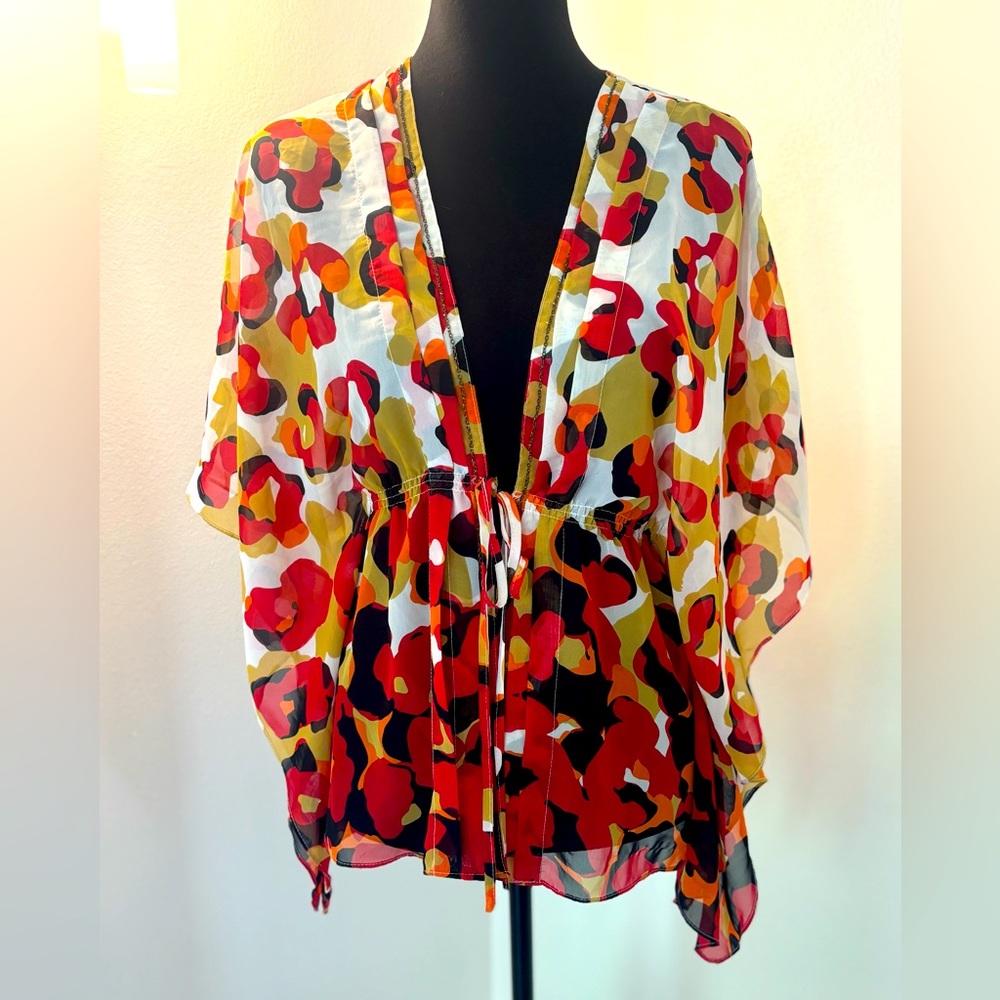 Sheer kimono style top. Tie closure with small chain detail.